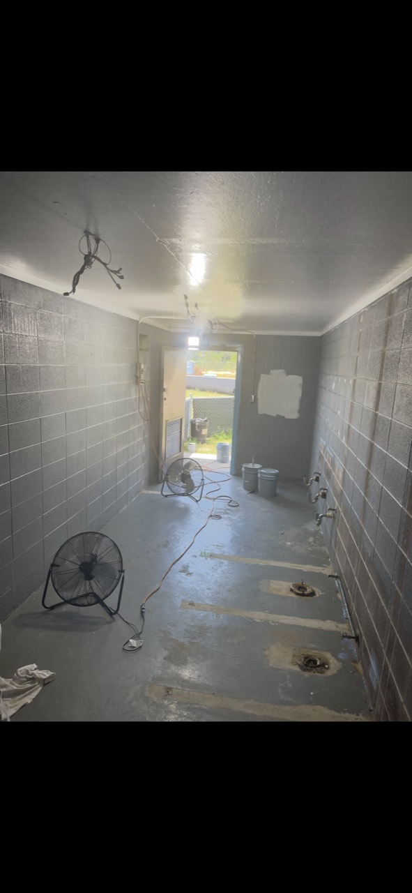 Commercial block restroom during cleaning and surface preparation
