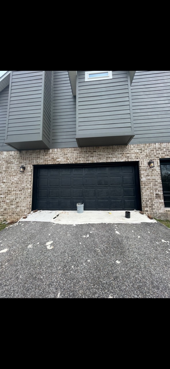 Black garage door repaint in progress